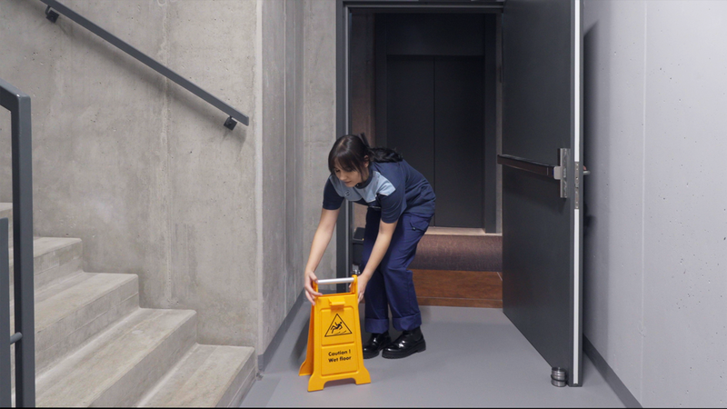 Woman putting up caution sign
