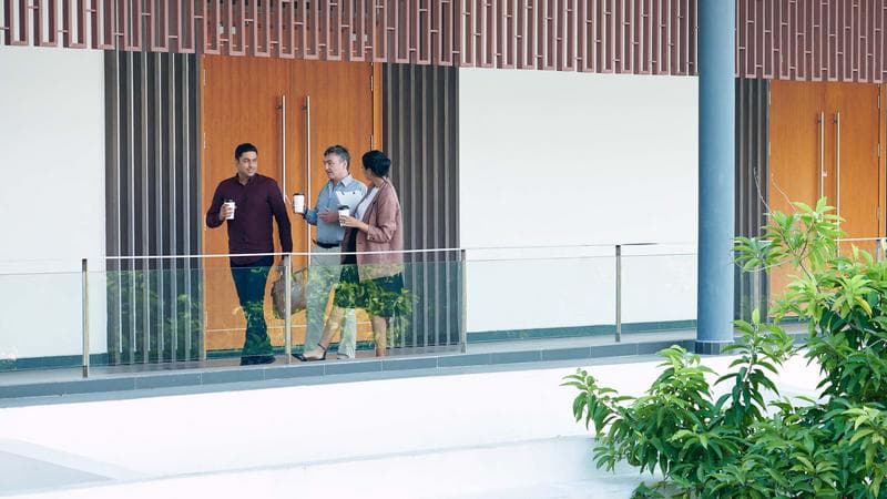 Successful business people hurrying to work when drinking morning coffee and discussing latest news
