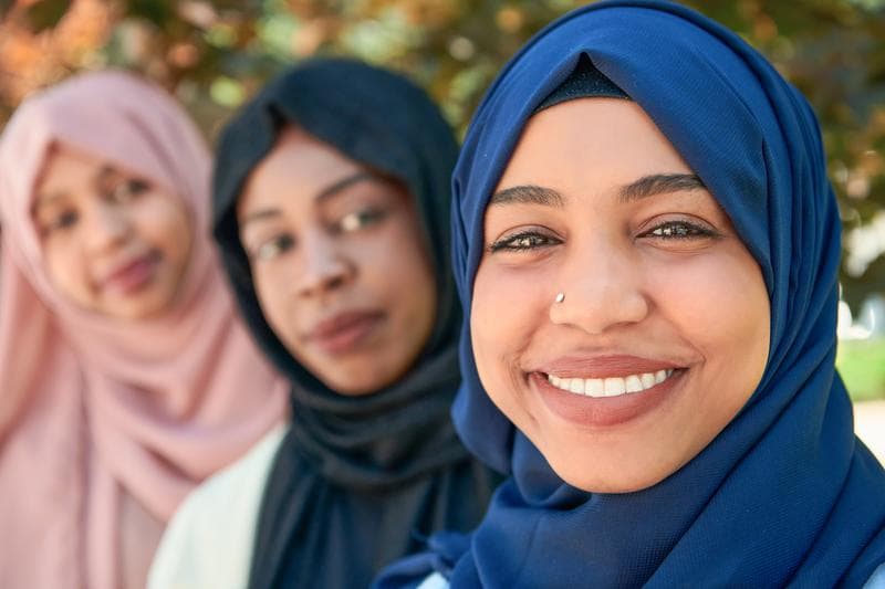 Businesswoman group portrait wearing traditional islamic clothes